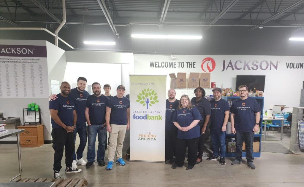 Convergence Networks team volunteering at the Greater Lansing Food Bank, sorting and packaging food donations for the community.