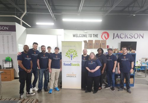 Convergence Networks team volunteering at the Greater Lansing Food Bank, sorting and packaging food donations for the community.