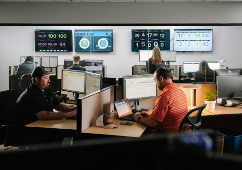 A business professional reviewing cybersecurity data on a laptop, highlighting the financial impact of data breaches